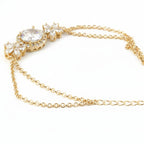SVORA Solitaire Oval Layered Bracelet with white CZ stones and rose gold plated chain. Features a large oval CZ surrounded by a halo and floral accents.