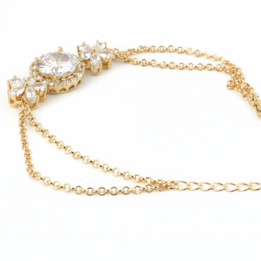 SVORA Solitaire Oval Layered Bracelet with white CZ stones and rose gold plated chain. Features a large oval CZ surrounded by a halo and floral accents.