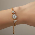 SVORA Solitaire Oval Layered Bracelet with white CZ stones and rose gold plated chain. Features flower accents.