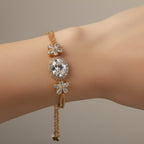 SVORA Solitaire Oval Layered Bracelet with white CZ stones and rose gold plated chain. Features flower accents.