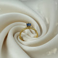 SVORA gold-plated stainless steel ring with a sapphire blue cubic zirconia solitaire.