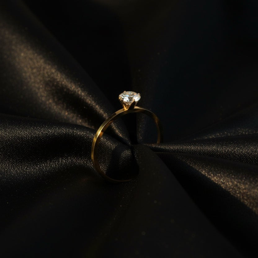 SVORA Lumiere Whisper Solitaire Ring in gold-tone stainless steel with cubic zirconia. Low-profile design.