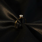 SVORA Lumiere Whisper Solitaire Ring in gold-tone stainless steel with cubic zirconia. Low-profile design.