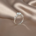 SVORA Ethereal Amour Solitaire Ring with clear round-brilliant center stone and heart-cut accent stones on rhodium-plated stainless steel band.