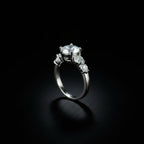 SVORA Ethereal Amour Solitaire Ring with round-brilliant center stone and heart-cut accent stones, rhodium-plated stainless steel.