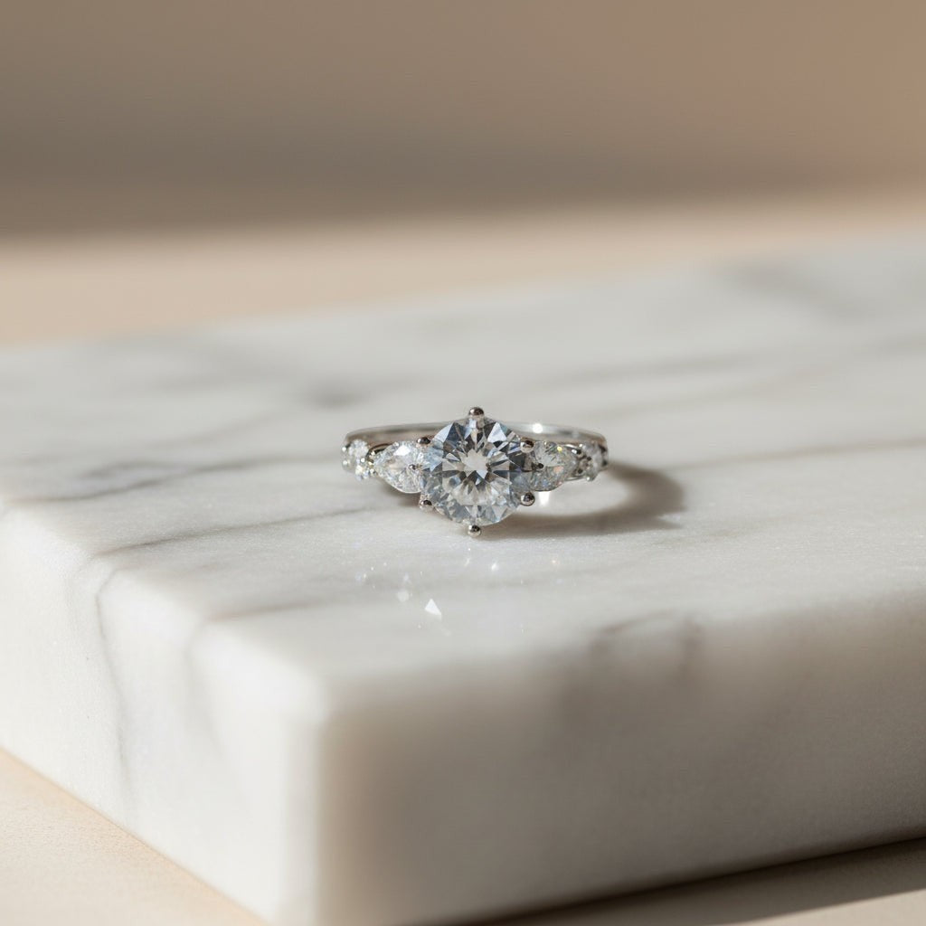 SVORA Ethereal Amour Solitaire Ring with round-brilliant center stone and heart-cut accent stones, rhodium-plated stainless steel.