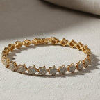 SVORA gold plated stainless steel tennis bracelet with pavé CZ stars and fold-over clasp.