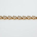 SVORA gold plated stainless steel tennis bracelet with pavé CZ stars and a fold-over clasp.