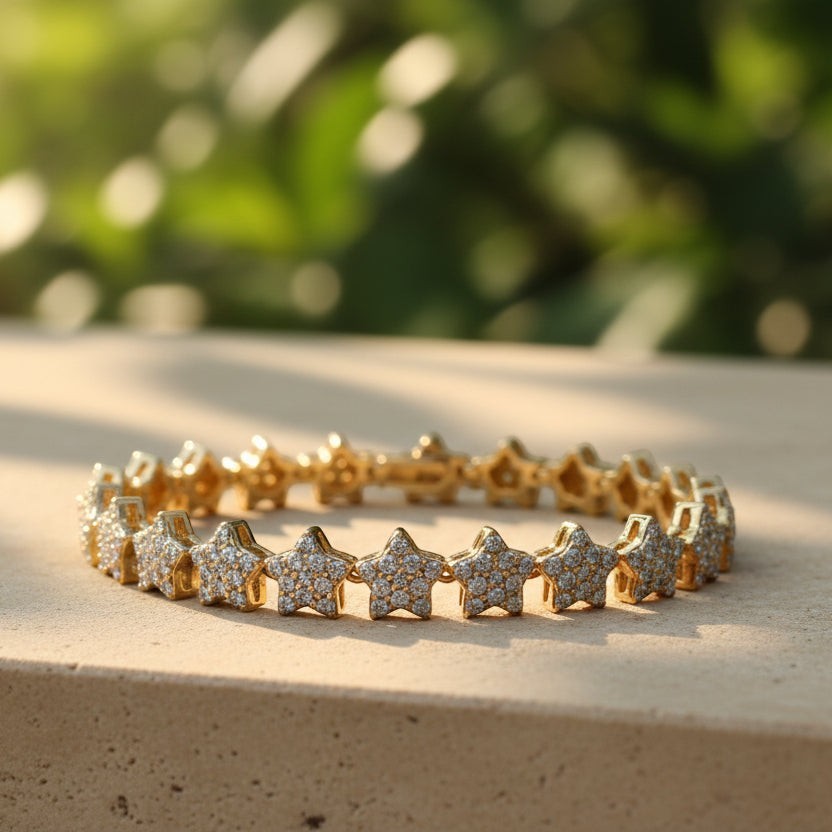 SVORA gold plated stainless steel tennis bracelet with pavé CZ stars and fold-over clasp.