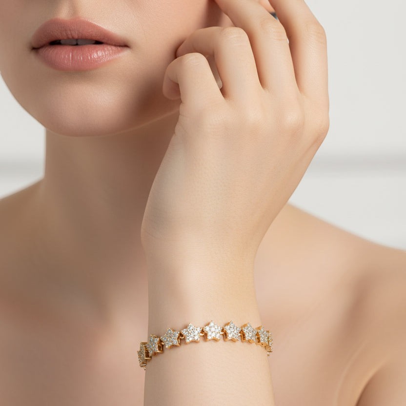 SVORA gold-plated stainless steel tennis bracelet with pavé CZ stars and a fold-over clasp.