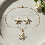 SVORA white enamel starfish necklace and earrings set with gold edges, 18K gold tone plating.