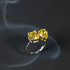 SVORA Toi et Moi Sunshine Ring with two yellow garnet stones, one emerald cut and one pear cut, on a silver band.