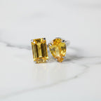 SVORA Toi et Moi Sunshine Ring with two yellow gemstones, one emerald cut and one pear cut, on a silver band.