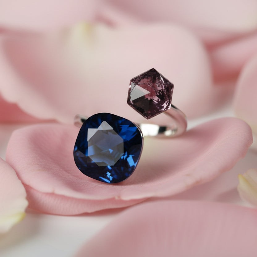 SVORA Toi et Moi ring with cushion-cut blue tanzanite and hexagonal purple stone on silver band.