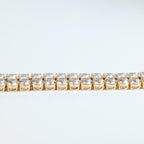 SVORA gold plated stainless steel tennis bracelet with two rows of large round white CZ stones and a fold-over clasp.