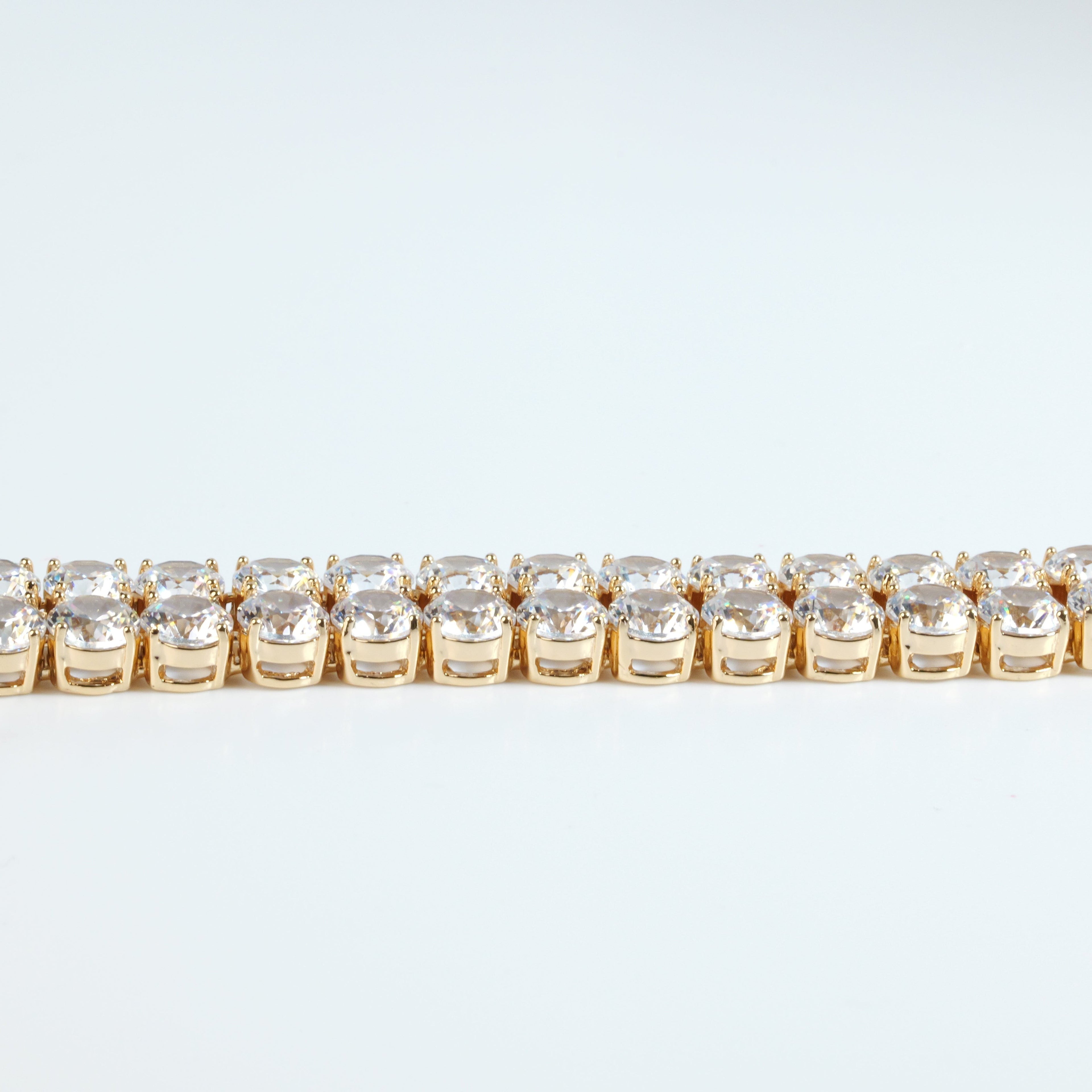 SVORA gold plated stainless steel tennis bracelet with two rows of large round white CZ stones and a fold-over clasp.