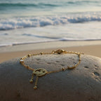SVORA gold plated stainless steel bracelet with three hearts charm and baguette CZs, adjustable clasp.