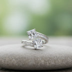 SVORA Toi et Moi ring with two princess-cut clear stones and channel-set baguettes on a rhodium-plated band.