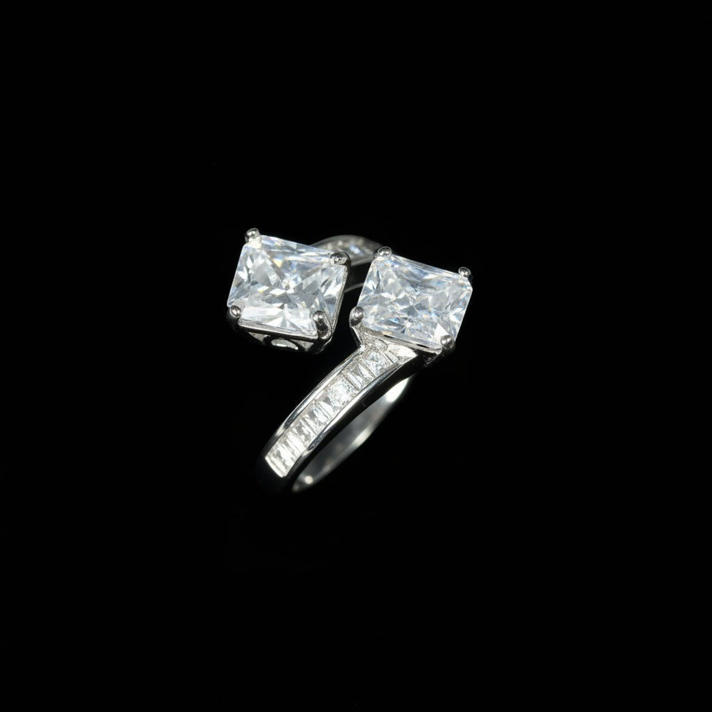 SVORA Toi et Moi ring with two princess-cut clear stones and channel-set baguettes on a rhodium-plated band.