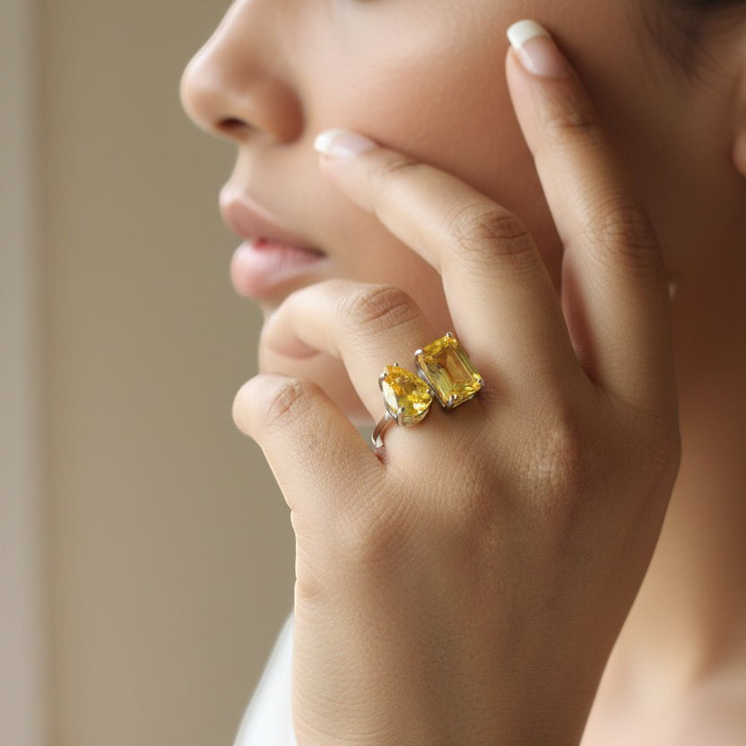 SVORA Toi et Moi Sunshine Ring with two yellow garnet stones, emerald and pear cut, on a silver band.
