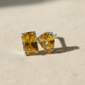 SVORA Toi et Moi Sunshine Garnet Ring with emerald and pear cut yellow stones on a silver band.