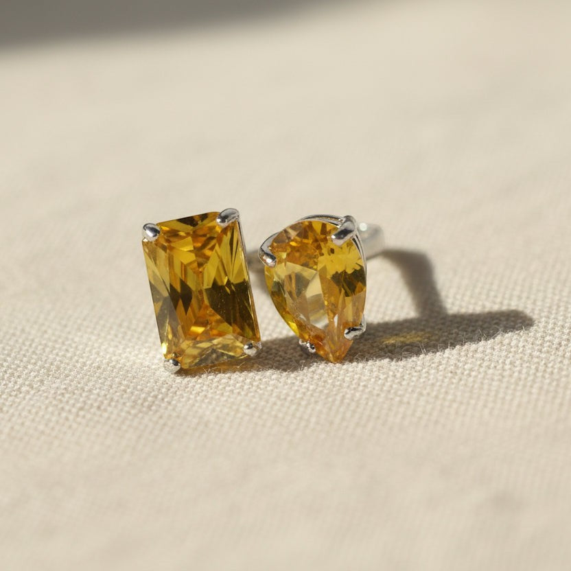 SVORA Toi et Moi Sunshine Garnet Ring with emerald and pear cut yellow stones on a silver band.