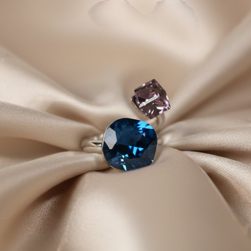 SVORA Toi et Moi ring with blue cushion and purple cube tanzanite stones on silver band.