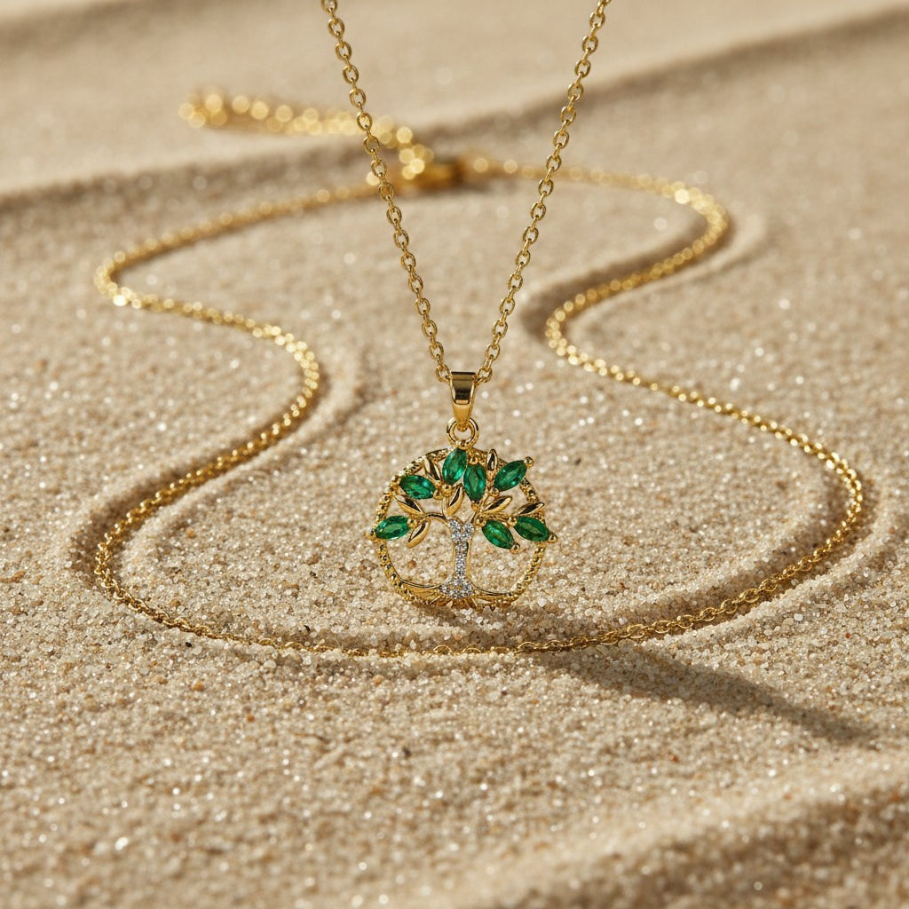 SVORA gold Tree of Life pendant necklace with emerald marquise CZ leaves and white CZ accent on a gold chain.