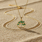 SVORA gold Tree of Life pendant necklace with emerald marquise CZ leaves and white CZ accent on a gold chain.