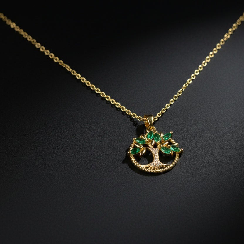 SVORA gold plated stainless steel pendant necklace with a Tree of Life design featuring emerald marquise CZ leaves and white CZ accents.