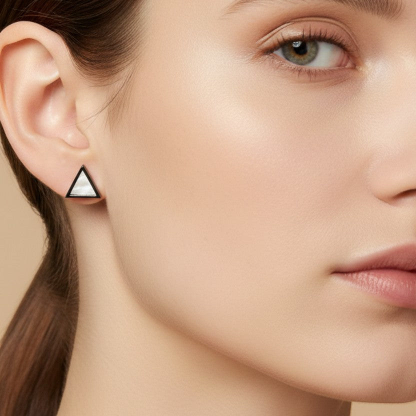 SVORA minimalist triangle stud earrings with iridescent pearl inlay, made of stainless steel with a gold tone finish.