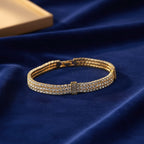 SVORA Triple Layer Tennis Bracelet with three rows of cubic zirconia stones in a gold-tone finish.