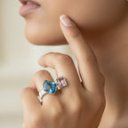 SVORA Toi et Moi Twilight Sapphire Ring with blue abstract-cut and pink emerald-cut stones on ribbed stainless steel band.