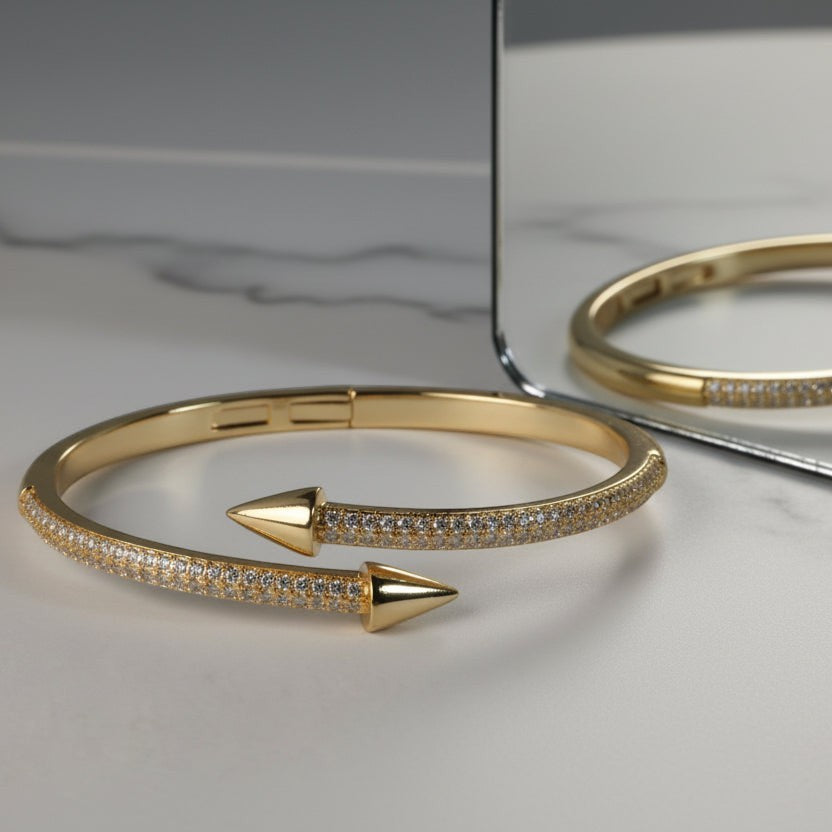 SVORA gold plated stainless steel bypass bracelet with two arrowheads and pavé cubic zirconia stones