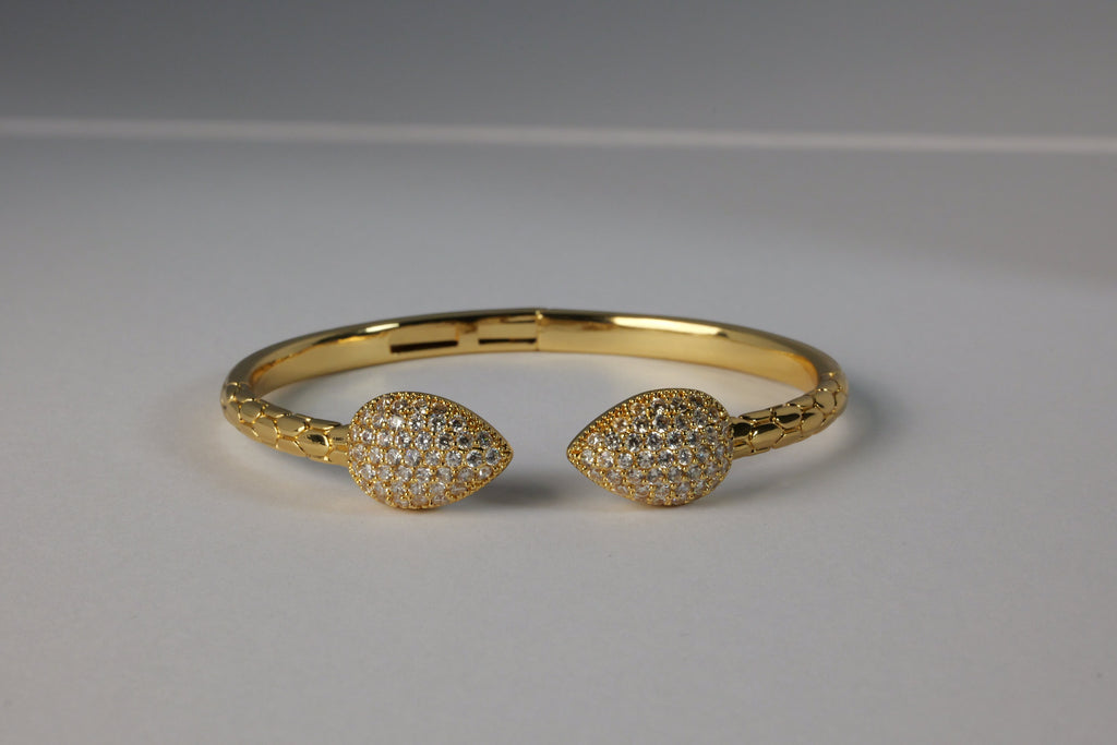 SVORA Twin Leaf Serpent Bracelet, gold-plated stainless steel cuff with pavé cubic zirconia leaves and scaled band.