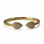 SVORA gold plated stainless steel cuff bracelet with pave cubic zirconia leaf ends and scaled band.