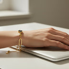 SVORA gold twisted rope chain bracelet with a black heart and two gold hearts. Adjustable.
