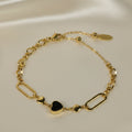SVORA gold twisted rope chain bracelet with a black heart charm and oval links. Adjustable.