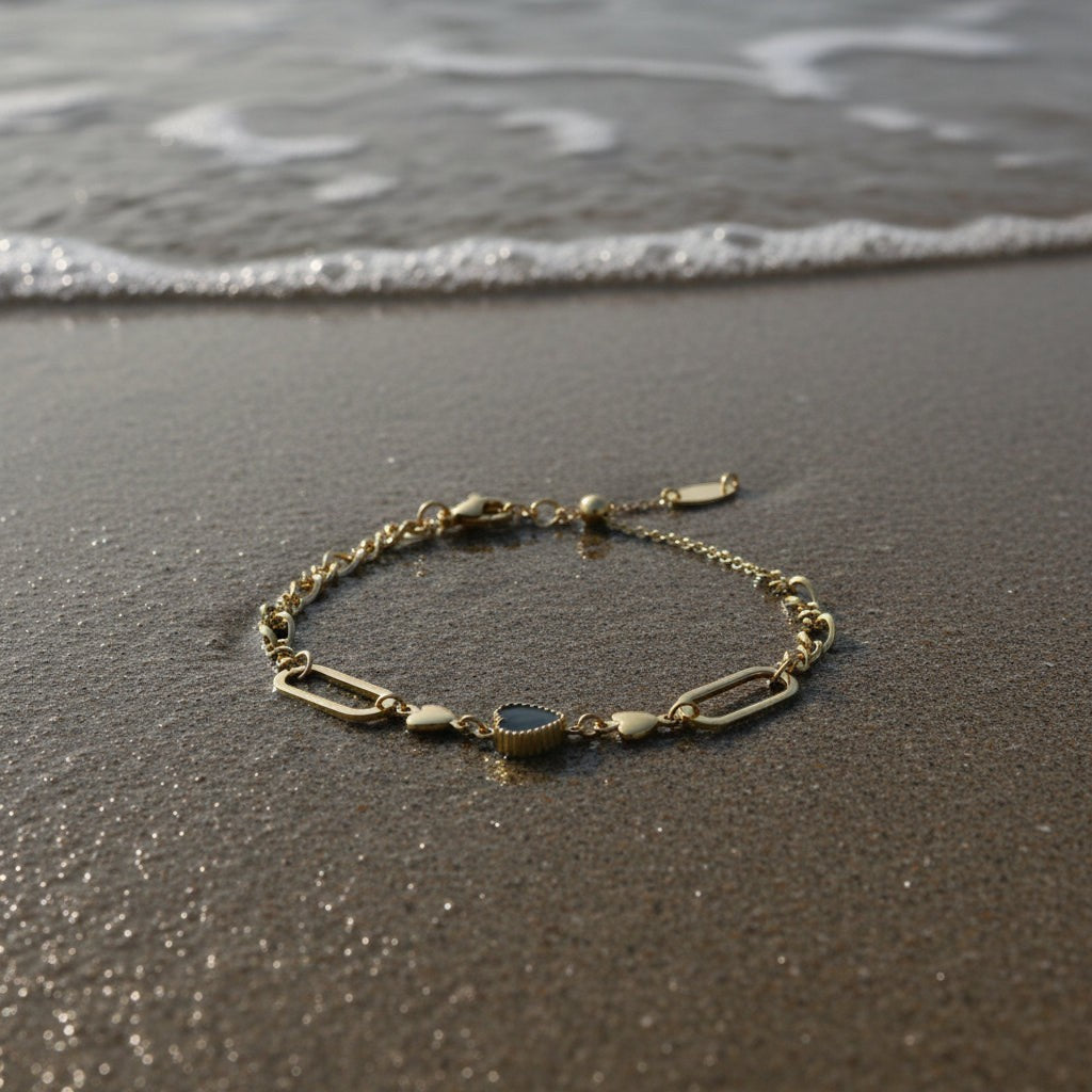 SVORA gold twisted rope chain bracelet with a black heart charm and oval links. Waterproof, anti-tarnish.