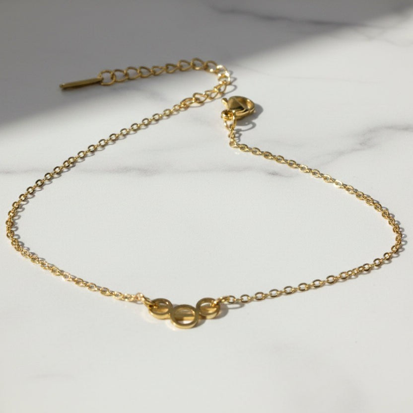 SVORA gold plated stainless steel bracelet with three openwork circles on a delicate chain. Adjustable, lobster clasp.