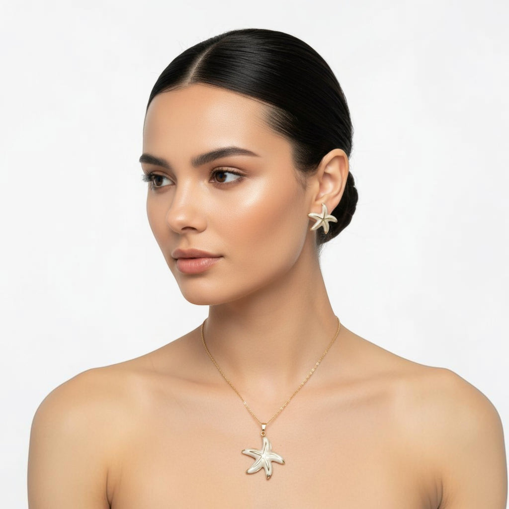 SVORA white pearlescent starfish necklace and earrings set with gold edges. Stainless steel with 18K gold tone plating.