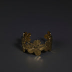 SVORA gold cuff bracelet with five sculpted floral blooms, diamond-cut finish, 18K gold plated stainless steel.