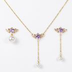 SVORA gold-tone necklace and asymmetric earrings set with purple heart charms and pearl drops.