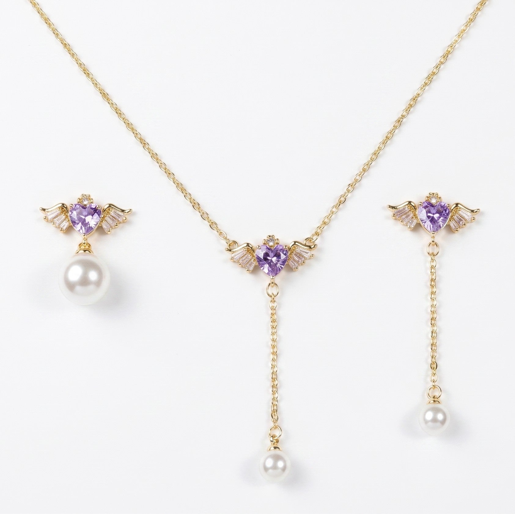SVORA gold-tone necklace and asymmetric earrings set with purple heart charms and pearl drops.