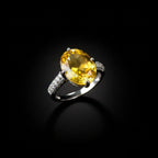 SVORA Ethereal Yellow Sapphire Solitaire Ring with oval-cut yellow stone and pavé shoulders on a silver band.
