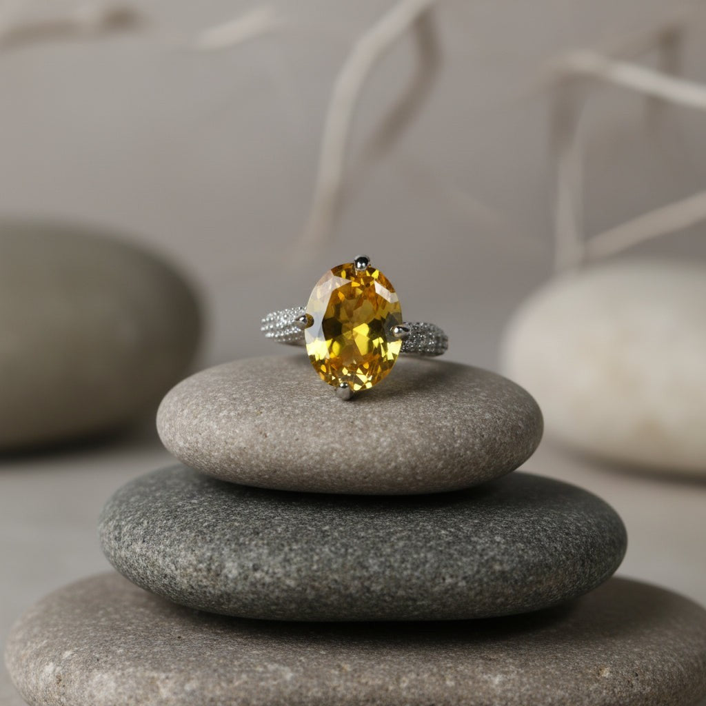 SVORA Ethereal Yellow Sapphire Solitaire Ring with oval-cut yellow stone and pavé shoulders on stainless steel.