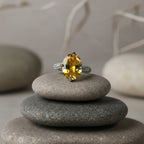 SVORA Ethereal Yellow Sapphire Solitaire Ring with oval-cut yellow stone and pavé shoulders on stainless steel.