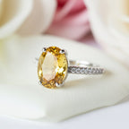SVORA Ethereal Yellow Sapphire Solitaire Ring with oval-cut yellow sapphire and pavé diamond band on rhodium-plated stainless steel.