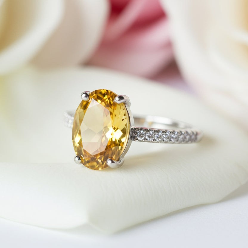 SVORA Ethereal Yellow Sapphire Solitaire Ring with oval-cut yellow sapphire and pavé diamond band on rhodium-plated stainless steel.